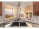 Kitchen sink featuring modern fixtures and a window with a serene backyard view at 14207 W Kiowa Trl, Surprise, AZ 85374