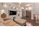 Spacious living room with stone accent wall, built-in shelving, and hardwood floors at 14207 W Kiowa Trl, Surprise, AZ 85374
