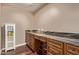 Office space featuring black granite countertops, drawers, and hardwood floors at 14207 W Kiowa Trl, Surprise, AZ 85374