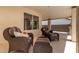 Relaxing covered patio area featuring comfortable wicker furniture and neutral colors at 14207 W Kiowa Trl, Surprise, AZ 85374