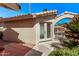 Side exterior entrance with double doors, a tile roof, and desert landscaping at 14207 W Kiowa Trl, Surprise, AZ 85374