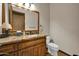 Bathroom featuring a sink with granite countertop, toilet, and shower-tub combination with a tile surround at 1423 E Breezy Ct, Phoenix, AZ 85086