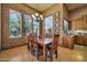 Bright dining room with natural light, a wood dining table, decorative chandelier, and views to the backyard at 1423 E Breezy Ct, Phoenix, AZ 85086