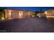 Spacious three-car garage with brick driveway in this luxurious home's exterior at 1423 E Breezy Ct, Phoenix, AZ 85086