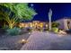 Charming home exterior with desert landscaping, featuring a brick walkway and nighttime illumination at 1423 E Breezy Ct, Phoenix, AZ 85086