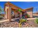 Southwest home with well-manicured desert landscaping, stone walkway, and covered porch at 1423 E Breezy Ct, Phoenix, AZ 85086