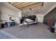 Spacious garage featuring epoxy flooring, built in cabinets, and a boat on a trailer at 1423 E Breezy Ct, Phoenix, AZ 85086