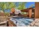 Outdoor spa with adjacent covered living area with built-in grill at 1423 E Breezy Ct, Phoenix, AZ 85086