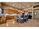 Spacious kitchen featuring a large island with barstool seating, complemented by custom cabinets and modern black appliances at 1423 E Breezy Ct, Phoenix, AZ 85086