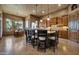 Open-concept kitchen with central island featuring stone accents, custom cabinetry, and an adjacent dining area at 1423 E Breezy Ct, Phoenix, AZ 85086