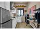 Efficient kitchen with stainless steel refrigerator and sleek white cabinetry at 1423 E Breezy Ct, Phoenix, AZ 85086