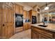 Close-up shot of kitchen featuring custom wood cabinets, granite counters, and state-of-the-art built-in black appliances at 1423 E Breezy Ct, Phoenix, AZ 85086
