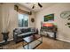 Bright living room featuring a comfy sofa and television, perfect for relaxation at 1423 E Breezy Ct, Phoenix, AZ 85086