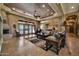 Bright and open living room featuring tile flooring, large windows, and a stone fireplace at 1423 E Breezy Ct, Phoenix, AZ 85086
