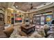 Comfortable living room with custom built-ins, a stone fireplace, and leather furniture at 1423 E Breezy Ct, Phoenix, AZ 85086