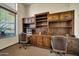 Home office with custom wood built-ins, dual desk areas, and ample storage at 1423 E Breezy Ct, Phoenix, AZ 85086