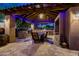 Outdoor kitchen and dining area features stone countertops, bar seating, and a built-in grill at 1423 E Breezy Ct, Phoenix, AZ 85086