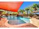 Inviting pool featuring a rock waterfall, landscaping, and relaxing lounge area at 1423 E Breezy Ct, Phoenix, AZ 85086