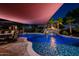 Stunning pool with waterfall feature and ambient lighting, perfect for relaxation and outdoor entertainment at 1423 E Breezy Ct, Phoenix, AZ 85086