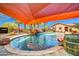 This backyard features a beautiful pool with waterfall, covered patio, and lush landscaping at 1423 E Breezy Ct, Phoenix, AZ 85086