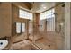 Tiled walk-in shower featuring glass enclosure and window, with granite countertop sink in background at 1423 E Breezy Ct, Phoenix, AZ 85086