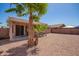 Gravel backyard with privacy fence, mature palm tree and covered patio at 14514 N 128Th Dr, El Mirage, AZ 85335