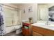 Bathroom with tub, shower, shower curtain, vanity, toilet and lavender decor at 14514 N 128Th Dr, El Mirage, AZ 85335