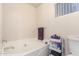 A pristine white soaking tub, neutral walls, and convenient storage cart at 14514 N 128Th Dr, El Mirage, AZ 85335