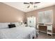 A bedroom with sleek flooring, white furniture, and a ceiling fan at 14514 N 128Th Dr, El Mirage, AZ 85335