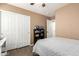 This bedroom features sliding closet doors, updated floors, and built-in shelves at 14514 N 128Th Dr, El Mirage, AZ 85335