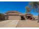 Charming single-story home boasts a well-maintained front yard, two-car garage, and a welcoming entrance at 14514 N 128Th Dr, El Mirage, AZ 85335