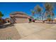 Charming single-story home boasts a well-maintained front yard, two-car garage, and a welcoming entrance at 14514 N 128Th Dr, El Mirage, AZ 85335