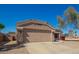 Charming single-story home boasts a well-maintained front yard, two-car garage, and a welcoming entrance at 14514 N 128Th Dr, El Mirage, AZ 85335