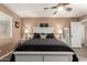 This main bedroom features light brown walls, decorative bedding, and natural light at 14514 N 128Th Dr, El Mirage, AZ 85335