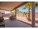 Covered patio with exterior furniture overlooking gravel backyard with privacy fence at 14514 N 128Th Dr, El Mirage, AZ 85335