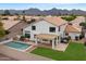 A high aerial view showing the pool, lush backyard and covered patio with beautiful mountain views at 14862 N 90Th Pl, Scottsdale, AZ 85260
