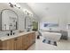Bright primary bathroom featuring dual vanities, soaking tub and modern finishes at 14862 N 90Th Pl, Scottsdale, AZ 85260