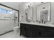 Modern bathroom boasts a double vanity, sleek mirrors, and a glass-enclosed shower at 14862 N 90Th Pl, Scottsdale, AZ 85260