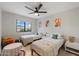 Shared bedroom is adorned with two twin beds, playful decor, and a bright window at 14862 N 90Th Pl, Scottsdale, AZ 85260