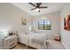 Cozy bedroom featuring a queen-sized bed, ceiling fan, and a picturesque window view at 14862 N 90Th Pl, Scottsdale, AZ 85260