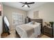 Comfortable bedroom showcasing a bed, dresser, and window with shutter blinds at 14862 N 90Th Pl, Scottsdale, AZ 85260