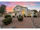 Lovely two-story home boasts a meticulously landscaped front yard with a stone water feature and mature trees at 14862 N 90Th Pl, Scottsdale, AZ 85260