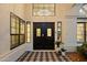 Elegant front entry with double doors, black and white tile, sidelights and views of a chandelier at 14862 N 90Th Pl, Scottsdale, AZ 85260