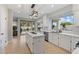 Modern kitchen boasts white cabinetry, center island, and a seamless flow to the outdoor living space at 14862 N 90Th Pl, Scottsdale, AZ 85260