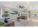 Living Room featuring multiple windows, ceiling fan, and large flat screen TV at 14862 N 90Th Pl, Scottsdale, AZ 85260