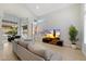 Open-concept living room featuring light wood floors, a vaulted ceiling, and modern furnishings at 14862 N 90Th Pl, Scottsdale, AZ 85260
