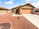 Single-story home with a gravel front yard and a two-car garage on a sunny day at 14950 W Rockrose Way, Surprise, AZ 85374