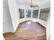 Living room with hardwood floors and a wall of windows offering natural light at 14950 W Rockrose Way, Surprise, AZ 85374