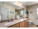 Bathroom featuring double sink vanity with granite countertop and large mirror at 15054 N 173Rd Dr, Surprise, AZ 85388