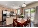 Eat-in kitchen includes stainless steel appliances, dark countertops, and wood dining set at 15054 N 173Rd Dr, Surprise, AZ 85388
